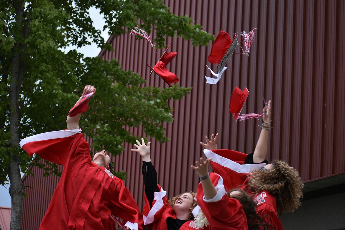 A group of SHS graduates toss their caps in the air following the ceremony Friday night.