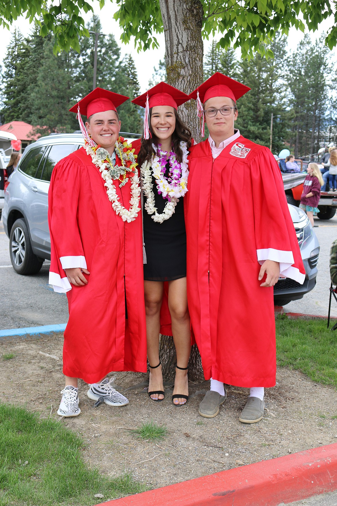 A trio of grads pose for a photo at Sandpoint High School commencement ceremony on Friday.