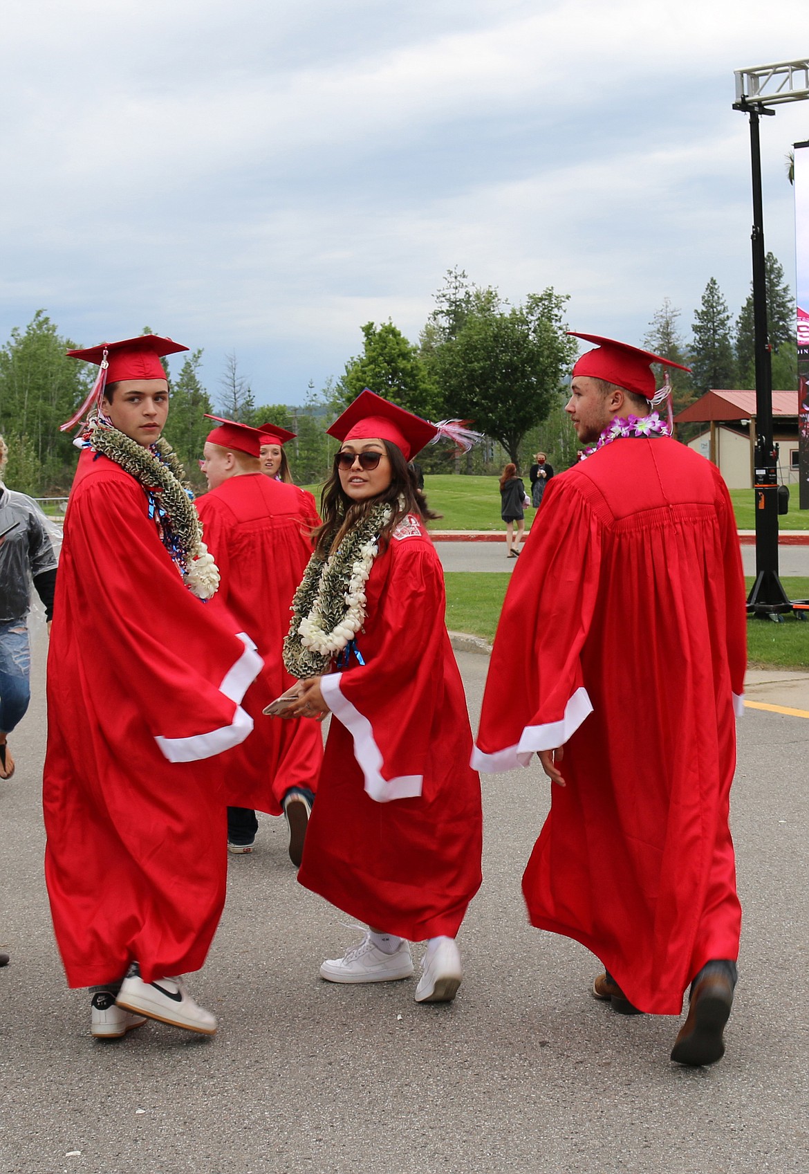 Colton Lunde, Zoey Barajas, and Spencer Rucker get ready to line up to walk across the stage in Friday’s Sandpoint High School commencement ceremony.