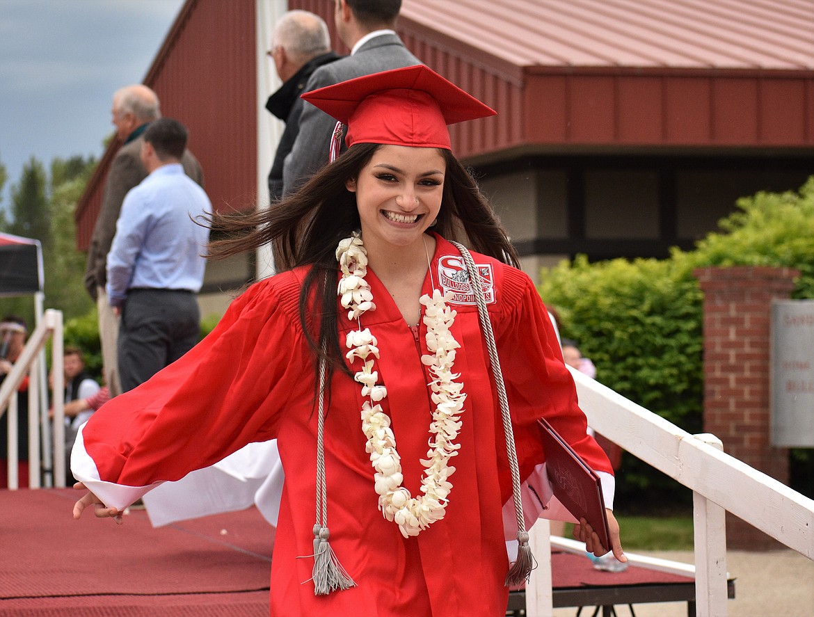 (Photo by DYLAN GREENE) 
 Bionce Vincent smiles after receiving her diploma.