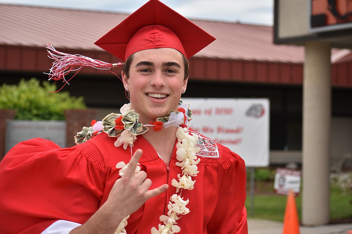 (Photo by DYLAN GREENE) 
 Christian Niemela celebrates after receiving his diploma.