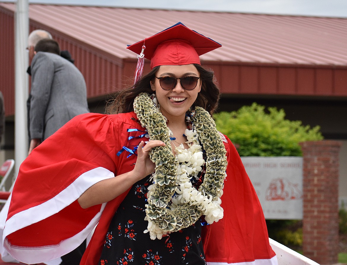(Photo by DYLAN GREENE) 
 An SHS grad celebrates after receiving her diploma.