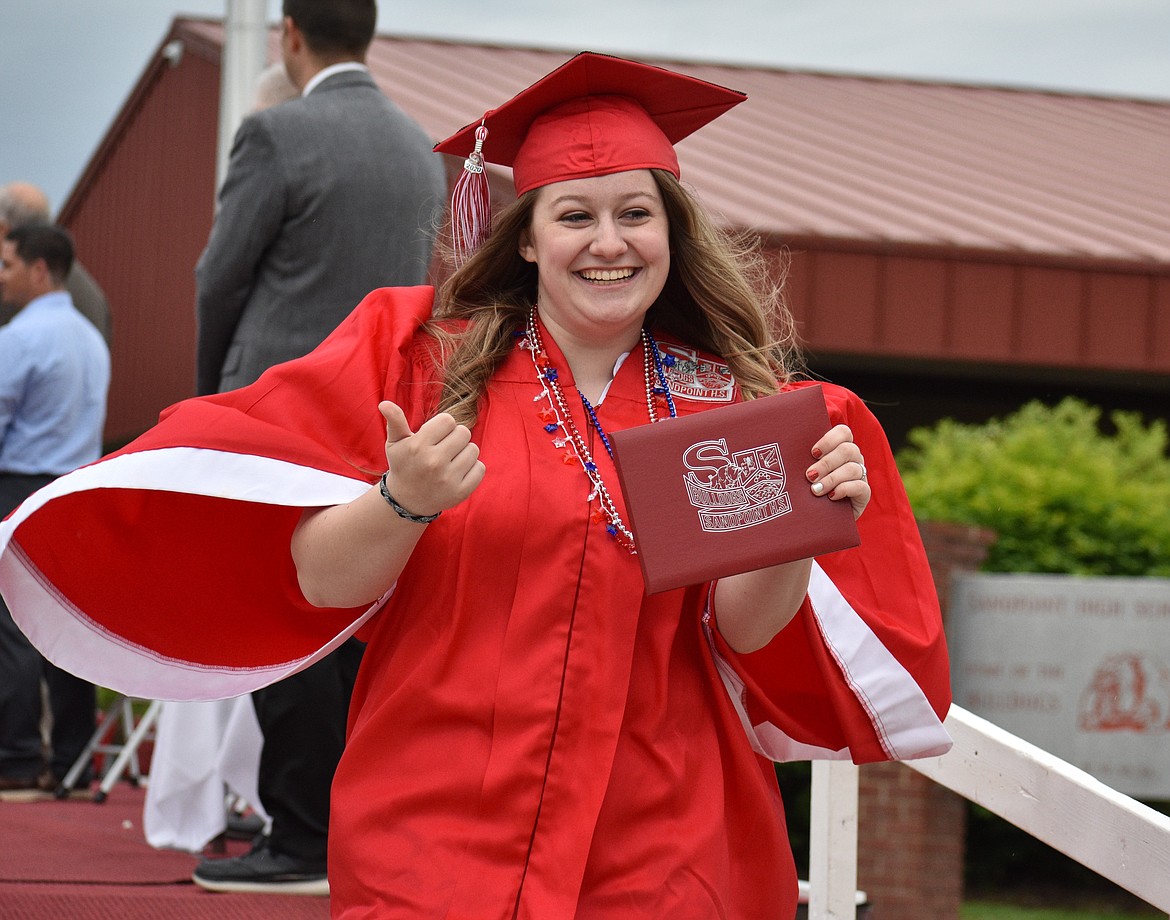 (Photo by DYLAN GREENE) 
 Jaycie Irish gives a thumbs up after grabbing her diploma.