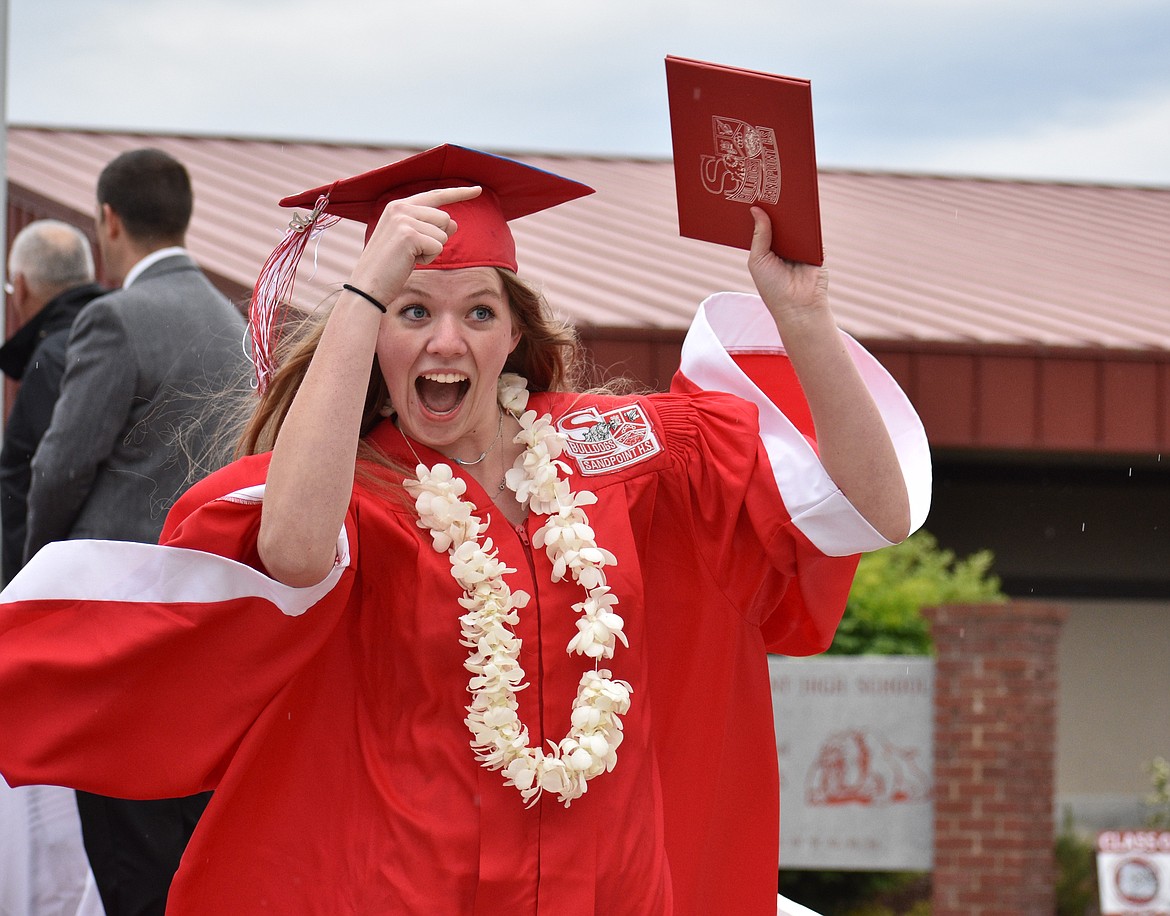 (Photo by DYLAN GREENE) 
 Katie Korn makes sure to point out that she just received her diploma.