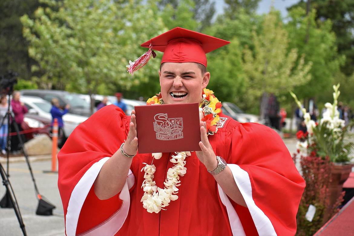 (Photo by DYLAN GREENE) 
 Sam Puckett celebrates after receiving his diploma.