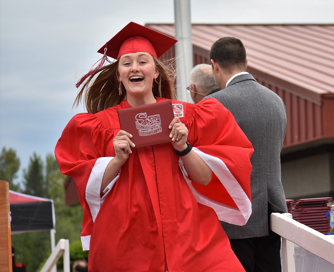 (Photo by DYLAN GREENE) 
 An SHS grad shows off her diploma.