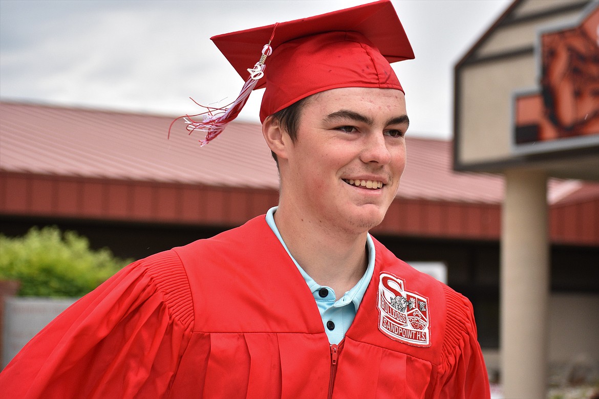 (Photo by DYLAN GREENE) 
 Wilson VanDenBerg smiles after receiving his diploma.