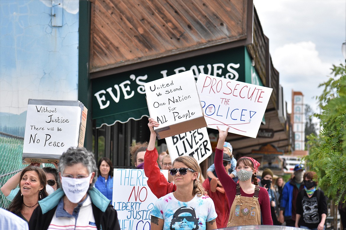 (Photo by DYLAN GREENE) 
 Protesters march down First Avenue in Sandpoint on Saturday.