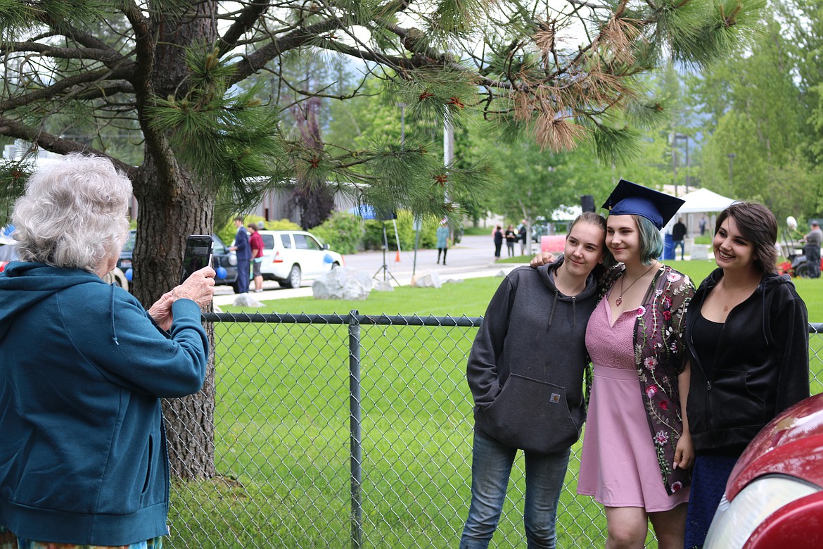 (Photo by CAROLINE LOBSINGER) 
 A Forrest M. Bird Charter School graduate gets her photo taken with family and friends at the school's graduation ceremony on Saturday.