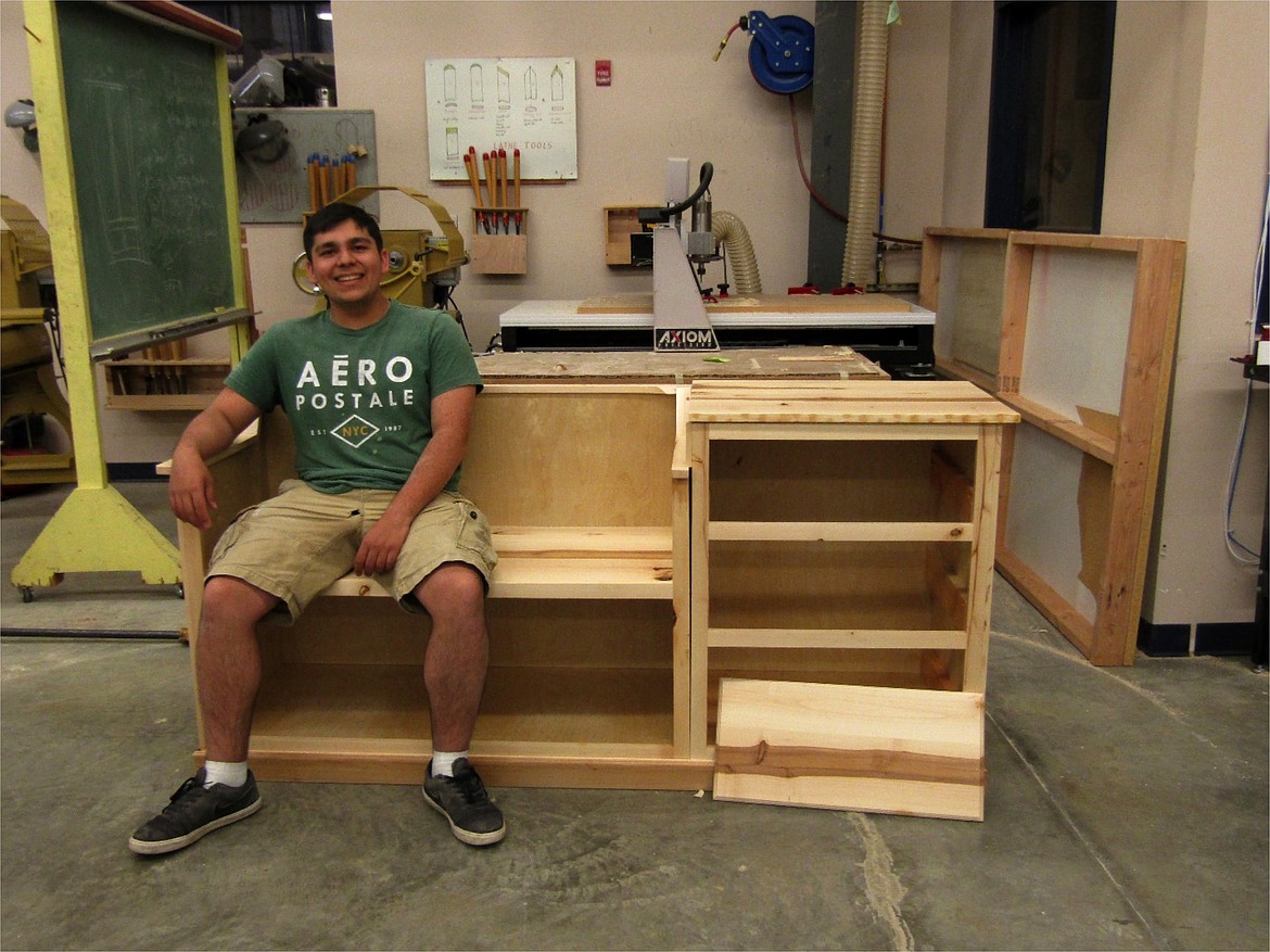 Michael Youngwirth and his entry way bench. This project is build from birch ply wood and alder. Each piece is separate for easy transport and assembly. Not pictured are his three drawers. Due to the virus he was not able to complete veneer inlay on this project as planned, however the project is still a spectacular way to finish his senior year.