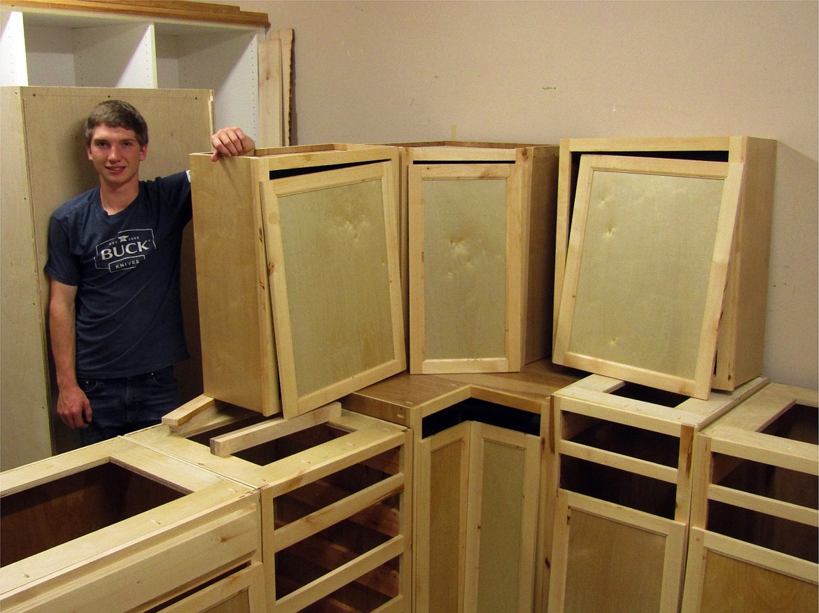 Ryker DesRosiers posing with some of his cabinets. Ryker’s project is constructed with birch plywood and alder face frames and doors.