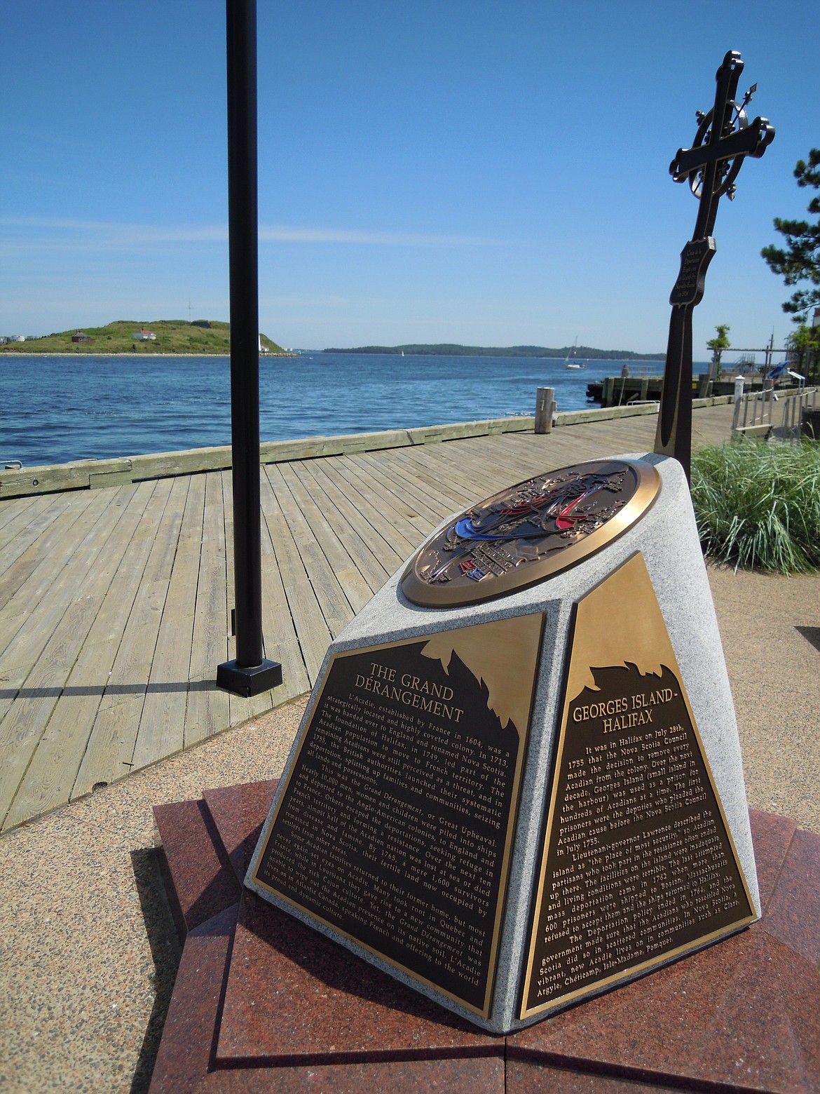 WIKIMEDIA COMMONS 
 Monument in Halifax harbor, Nova Scotia, commemorating the use of Georges Island as a prison for deported Acadians during the Grand Dérangement of the 1750s and 1760s, showing Georges Island nearby.