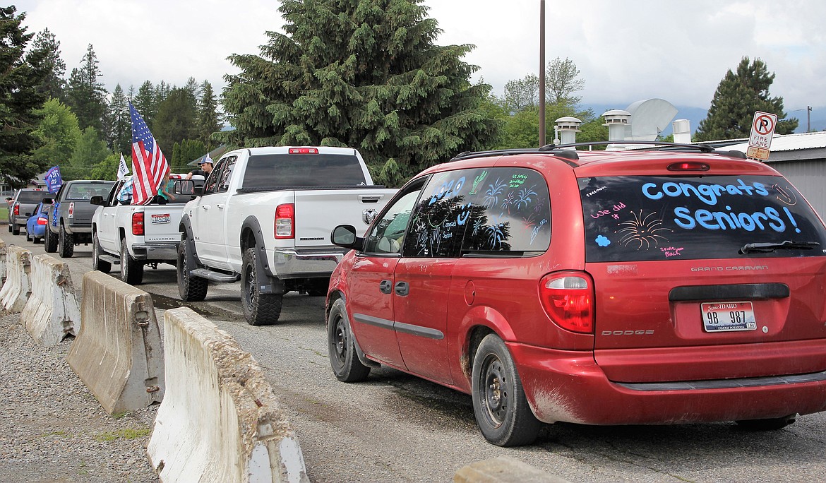 (Photo by TONIA BROOKS) 
 Families and their graduates lined up to receive their diploma via drive up service. Most vehicles were festively decorated and filled with happy people.