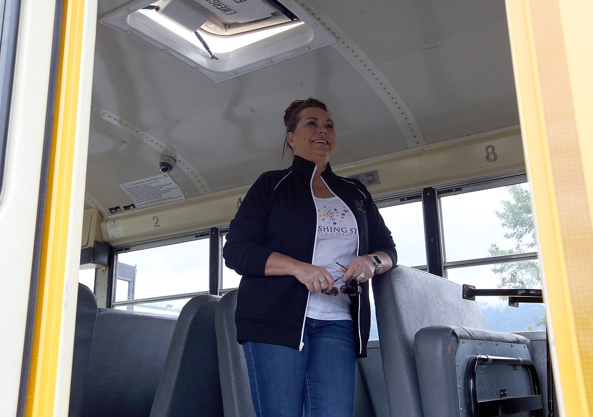 Lonna Smith, executive director of the Wishing Star Foundation in Spokane, smiles as she checks on the inside of what will be Benji’s bus on Wednesday at Bay Shore Systems in Rathdrum.