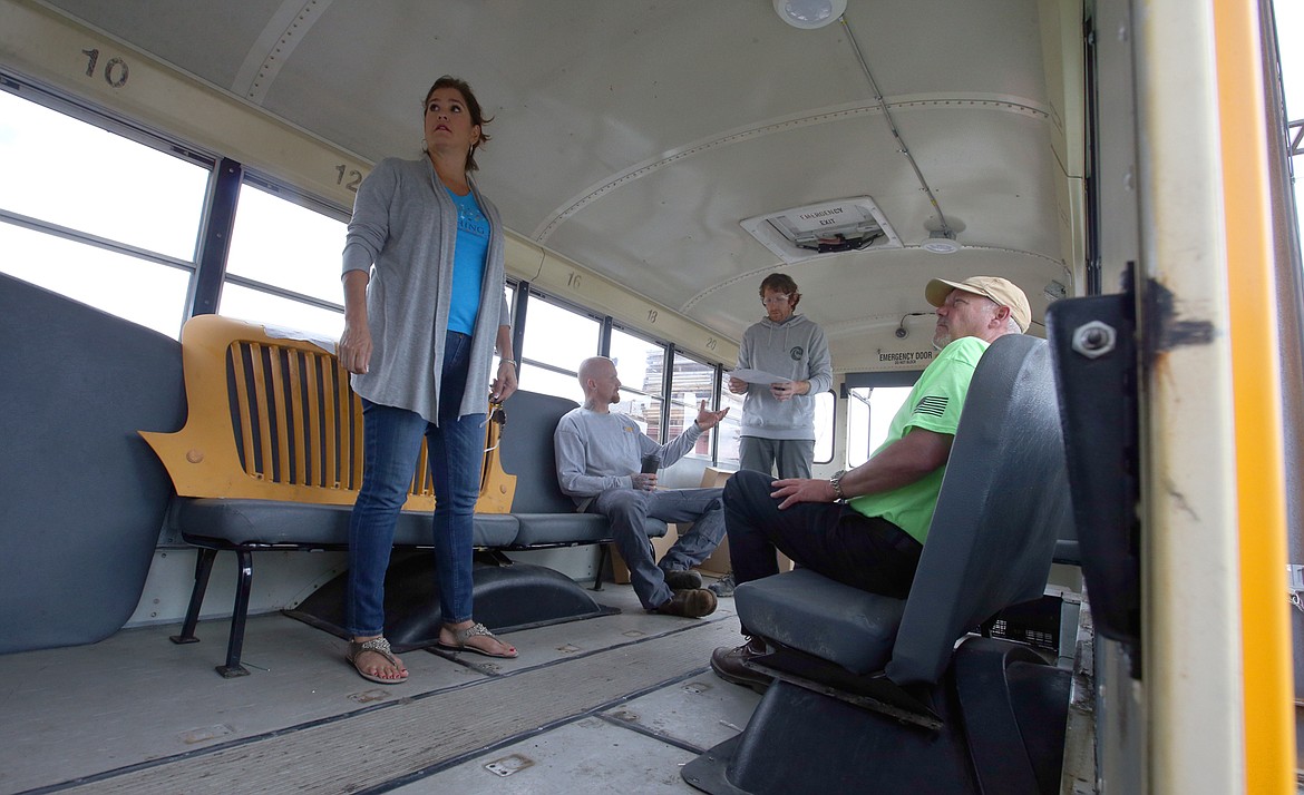 BILL BULEY/Press 
 Cindy Guthrie, Wishing Star Foundation director of donor relations, stands in the school bus being retrofitted Wednesday at Bay Shore Systems. She is joined by, from left, Bob Beamis and Josh Fitzgerald with Bay Shore, and Mark Peterson with the KXLY Extreme Team.