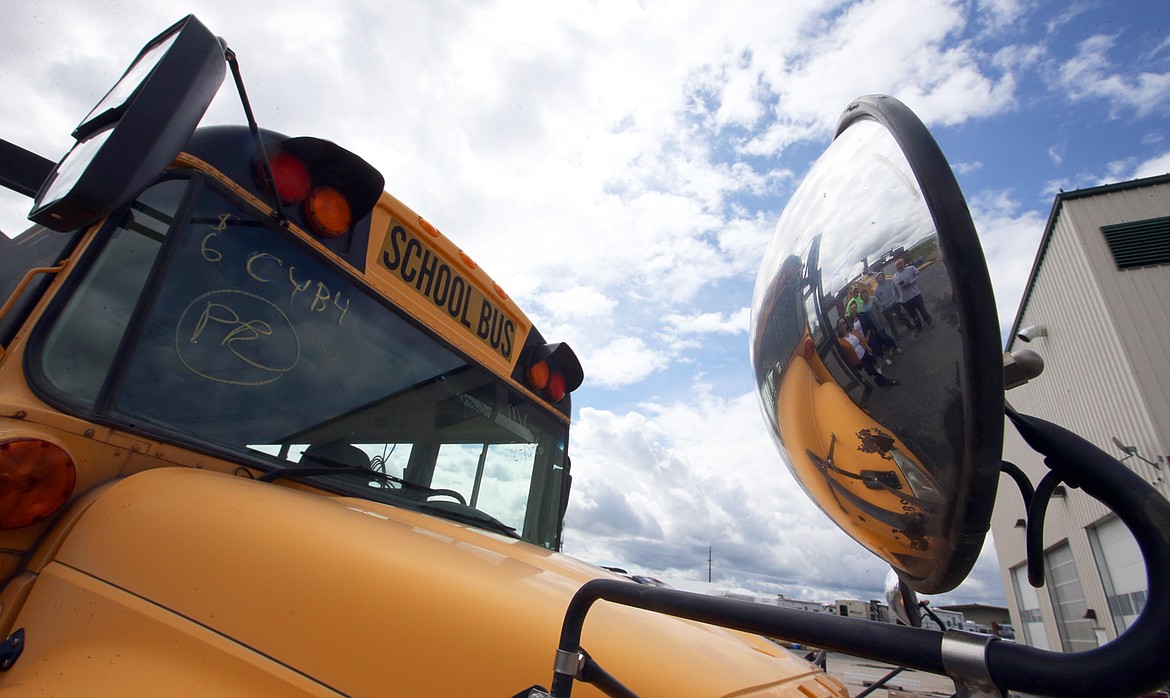 BILL BULEY/Press 
 The mirror reflects those involved in renovating a school bus for Benji through the Wishing Star Foundation. From left are Andrea Kilgore, Lonna Smith, Cindy Guthrie, Mark Peterson in back, Josh Fitzgerald and Bob Beamis.