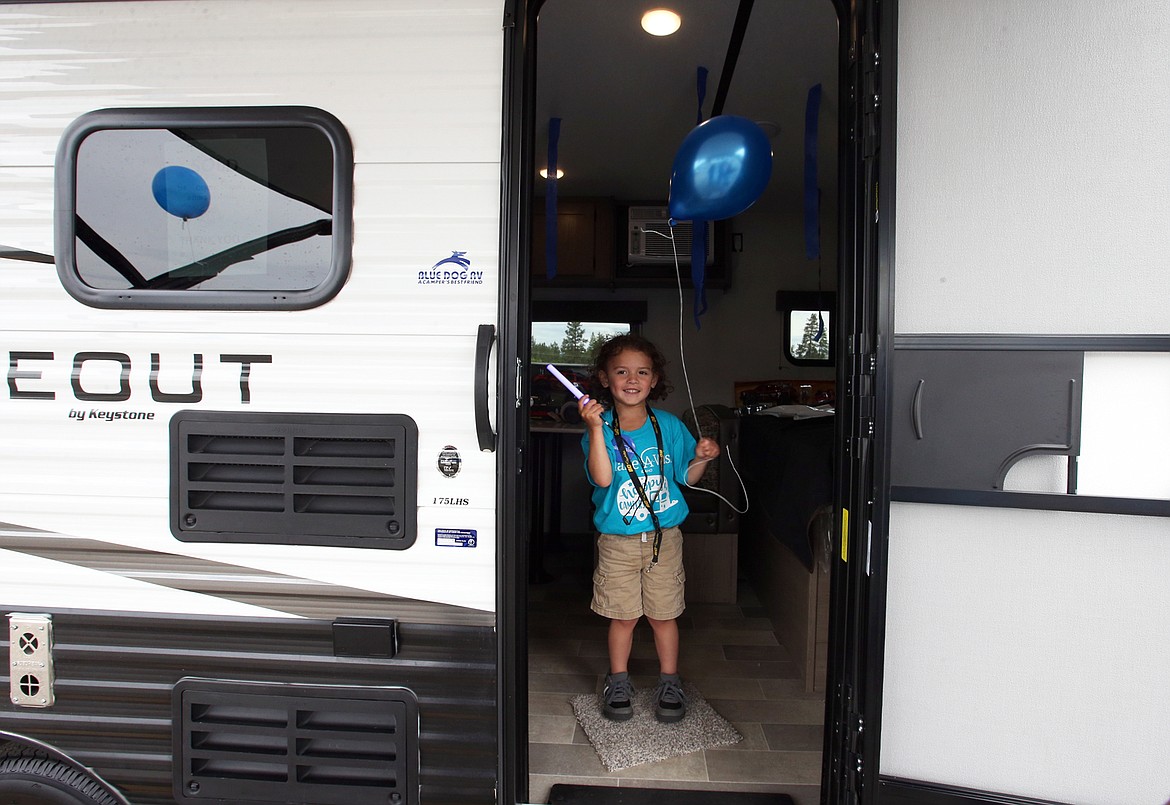 BILL BULEY/Press 
 Christopher Blood looks out the door of his family's new RV courtesy of the Make-A-Wish Foundation on Thursday at Blue Dog RV in Post Falls.