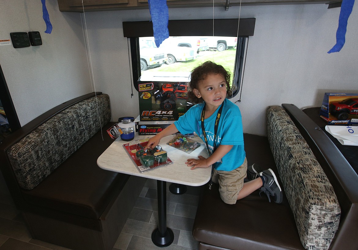 BILL BULEY/Press 
 Christopher Blood checks out some of his new toys that came with his family's new RV courtesy of the Make-A-Wish Foundation on Thursday at Blue Dog RV in Post Falls.