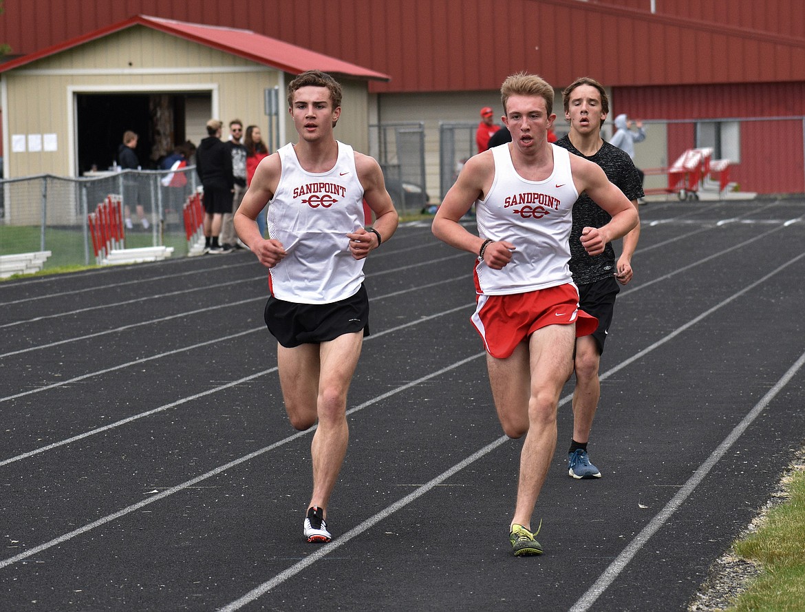 (Photo by DYLAN GREENE) 
 Sandpoint seniors Brady Nelsen (left) and Gabe Christman run side-by-side in the boys 3,200 meter.