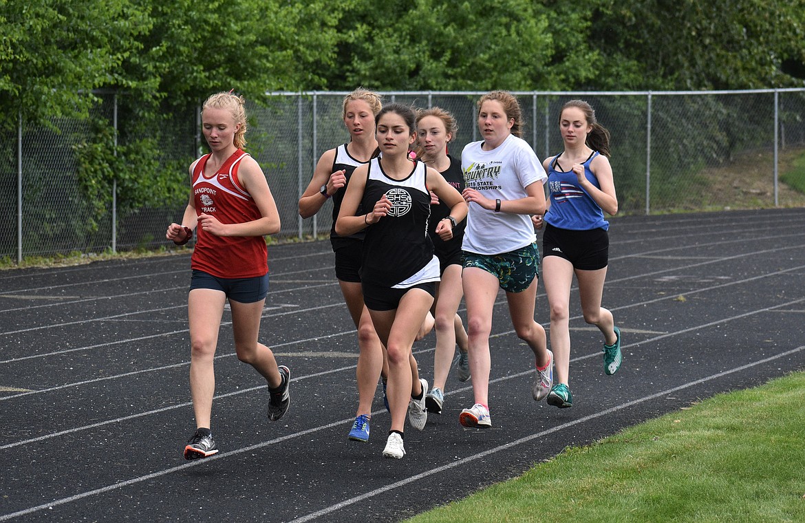 (Photo by DYLAN GREENE) 
 A pack of runners compete in the girls 1,600 Saturday.