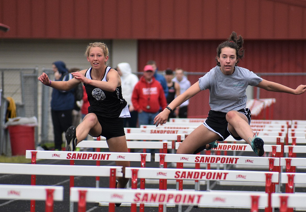 (Photo by DYLAN GREENE) 
 Paige Davidson (left) and Sara Hathaway compete in the girls 100 meter hurdles Saturday.