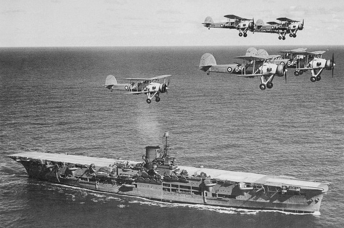 WIKIMEDIA COMMONS 
 These old Swordfish aircraft carrying torpedoes, shown here flying over British aircraft carrier HMS Ark Royal helped sink the mighty battleship Bismarck.