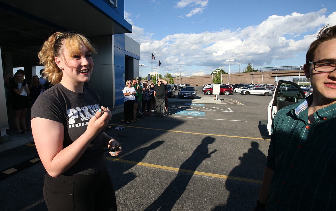 BILL BULEY/Press 
 Amy Palmer smiles after Brian Hansen gave her the key to the 2019 Chevy Trax he won Thursday at Knudtsen Chevrolet in Post Falls.