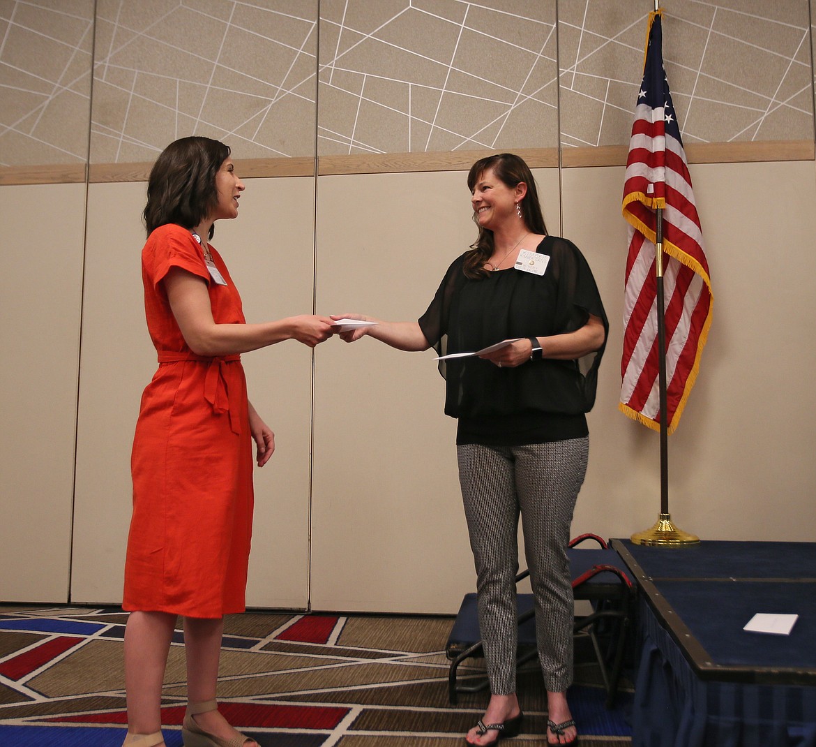 Tarah Boerner, registered dietitian nutritionist with Panhandle Health District, left, accepts a check for $1,000 from Rotary President Kimber Gates during a grant distribution in The Coeur d'Alene Resort on Friday. The funds will go to Panhandle's Parents Leading Active Youth program, which empowers parents to serve as positive role models and lead their children in healthy habits. (DEVIN WEEKS/Press)