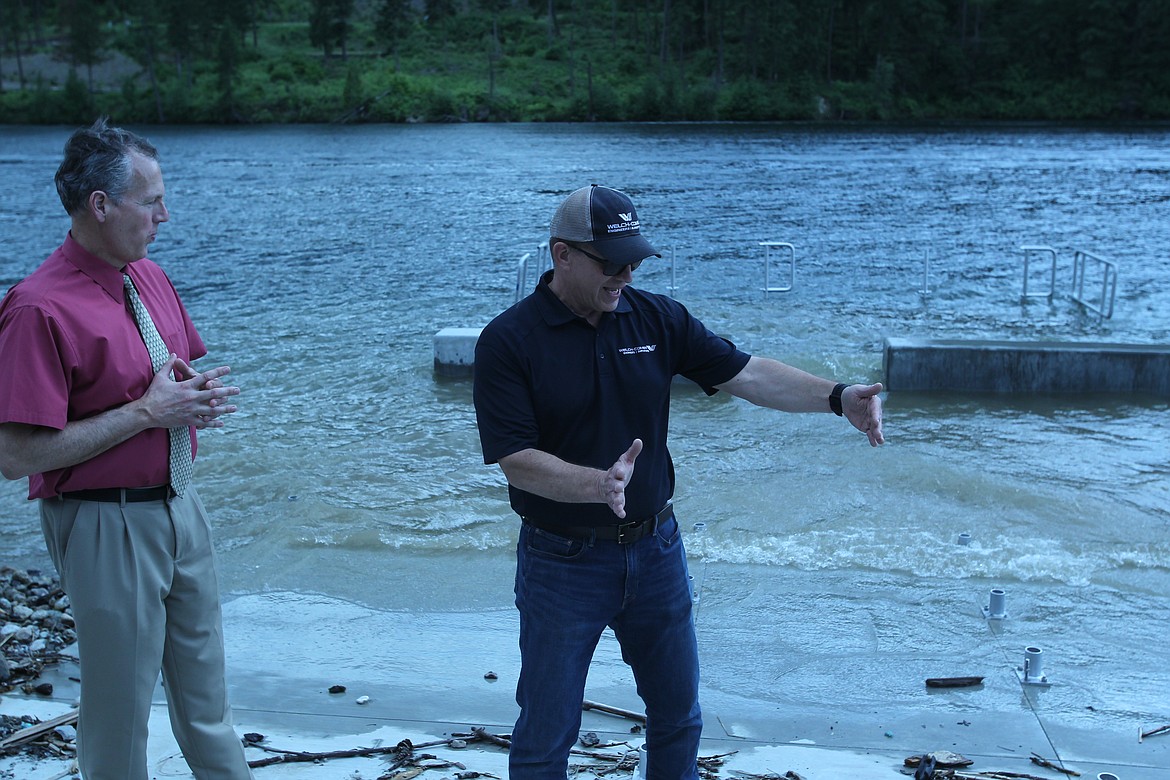 Attentive city administrator Troy Tymesen (left) listens in as Phil Boyd of Welch-Comer explains the thought process behind an ADA-accessible dock to help people with limited mobility access the Spokane River. (CRAIG NORTHRUP/Press)