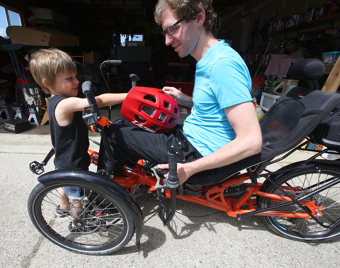 BILL BULEY/Press 
 Nick Maniscalco of Dalton Gardens visits with his neighboras he shows the bike he plans to ride across the United States next year.