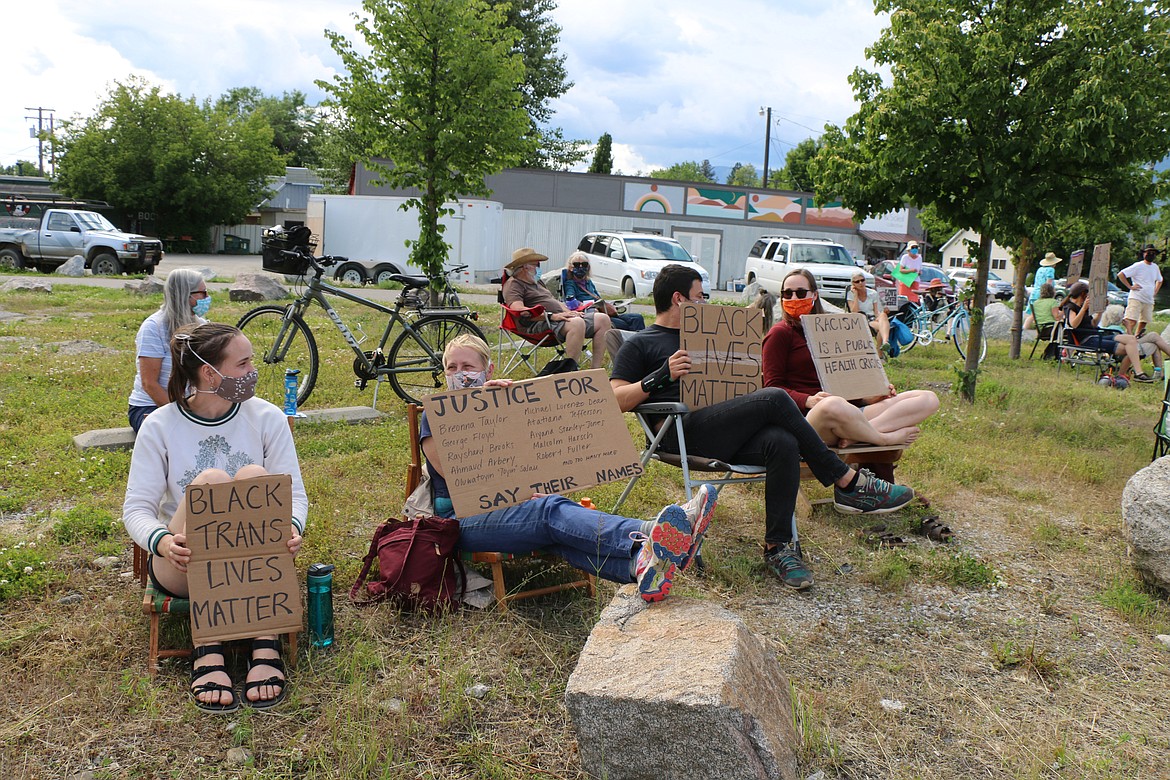 (Photo by CAROLINE LOBSINGER) 
 Participants gather for a Juneteenth sit-in at the corner of Fourth and Cedar on Friday. The holiday commemorates June 19, 1865 — the date the last slaves in the United States were freed — about two years after the Emancipation Proclamation in 1863.