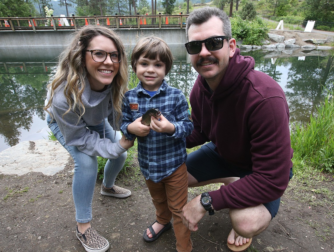 BILL BULEY/Press 
 Justin and Kimberly Moehle and son Nolan enjoy the fishing derby at Falls Park on Saturday.