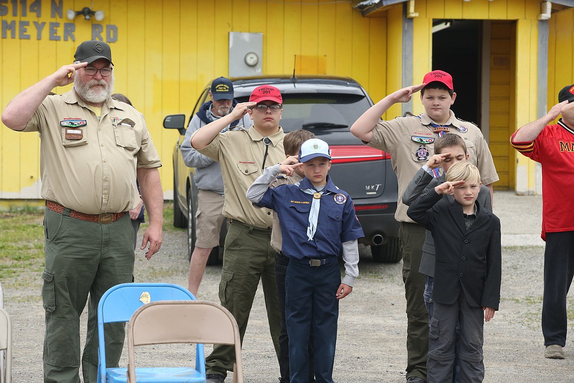 BILL BULEY/Press
Mike Dolan, Scout leader, left and Scouts, back from left, RJ Marquez and James Laker; second row, obscured, Colby Miller and Stefan Gabriel; and front row, Michael Gallus and Andrew Gabriel, salute during Saturday’s flag retirement ceremony at the Rathrdrum Lions Club.