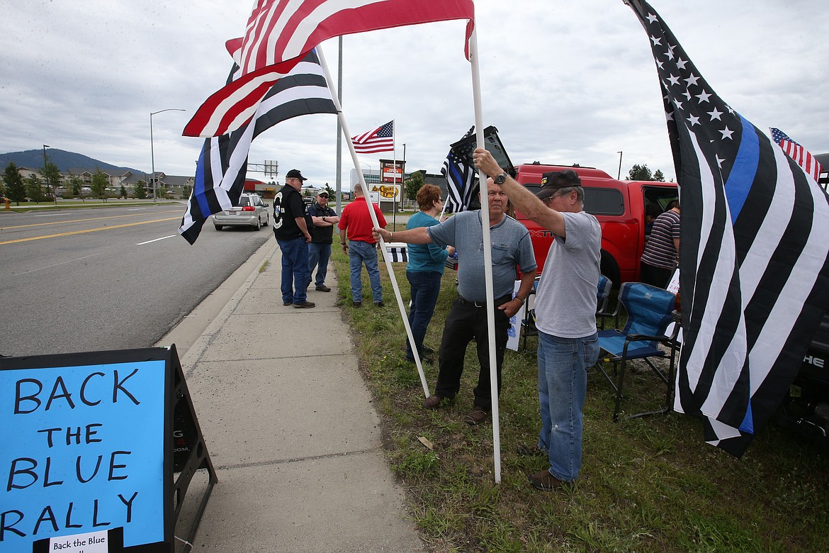 BILL BULEY/Press 
 John Wilson and Denny Watson chat at they join the "Back the Blue" rally at Appleway and Ramsey on Saturday.