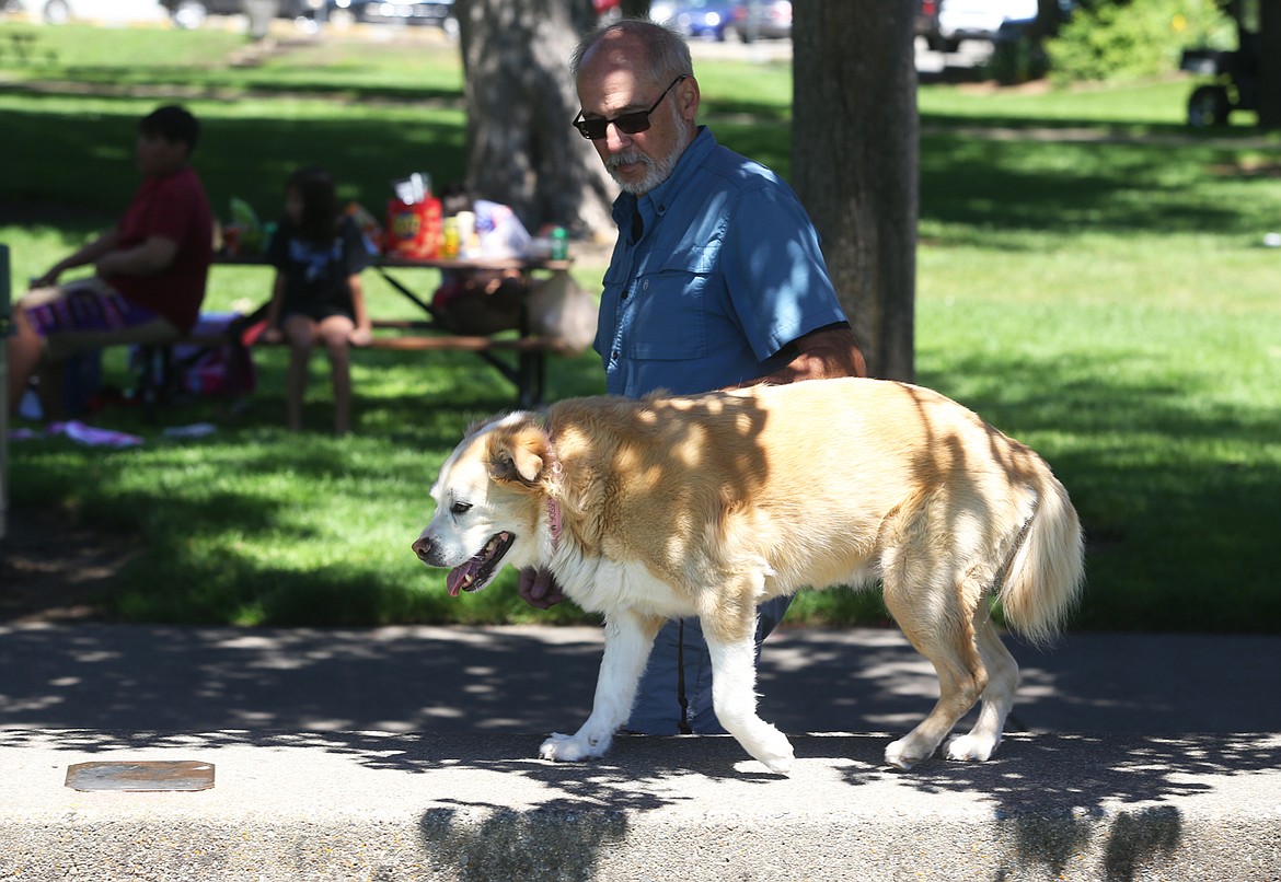 BILL BULEY/Press 
 Bob Aha walks his dog Emma at City Park on Monday.