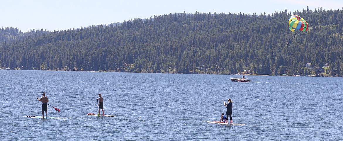 BILL BULEY/Press 
 Paddleboards and a parasailer head out on Lake Coeur d'Alene on Monday.