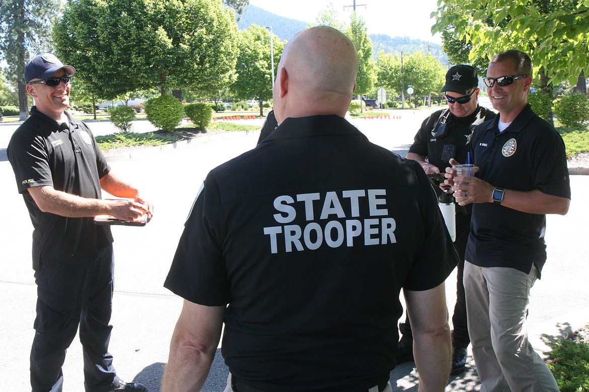 Sgt Shane Avriett (left) of the Coeur d’Alene police and fellow motor officers, Rob Davis of ISP, and Nick Knoll of CPD congratulate ISP Trooper Todd McDevitt  on passing the third phase of his certification test.
Ralph Bartholdt/Press