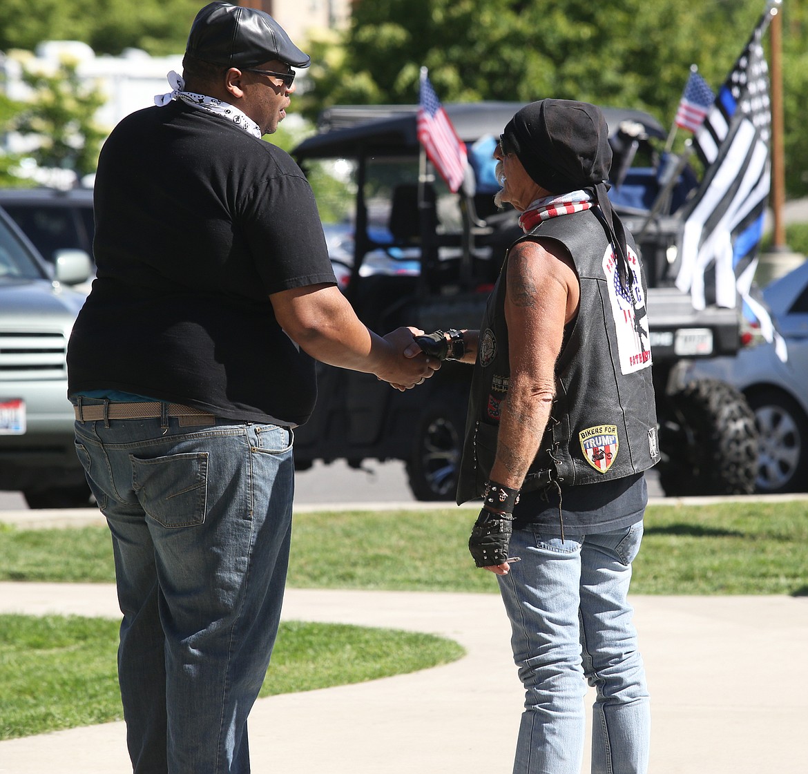 BILL BULEY/Press 
 Two men shake hands during the BLM protest and counter-rally at McEuen Park on Tuesday.