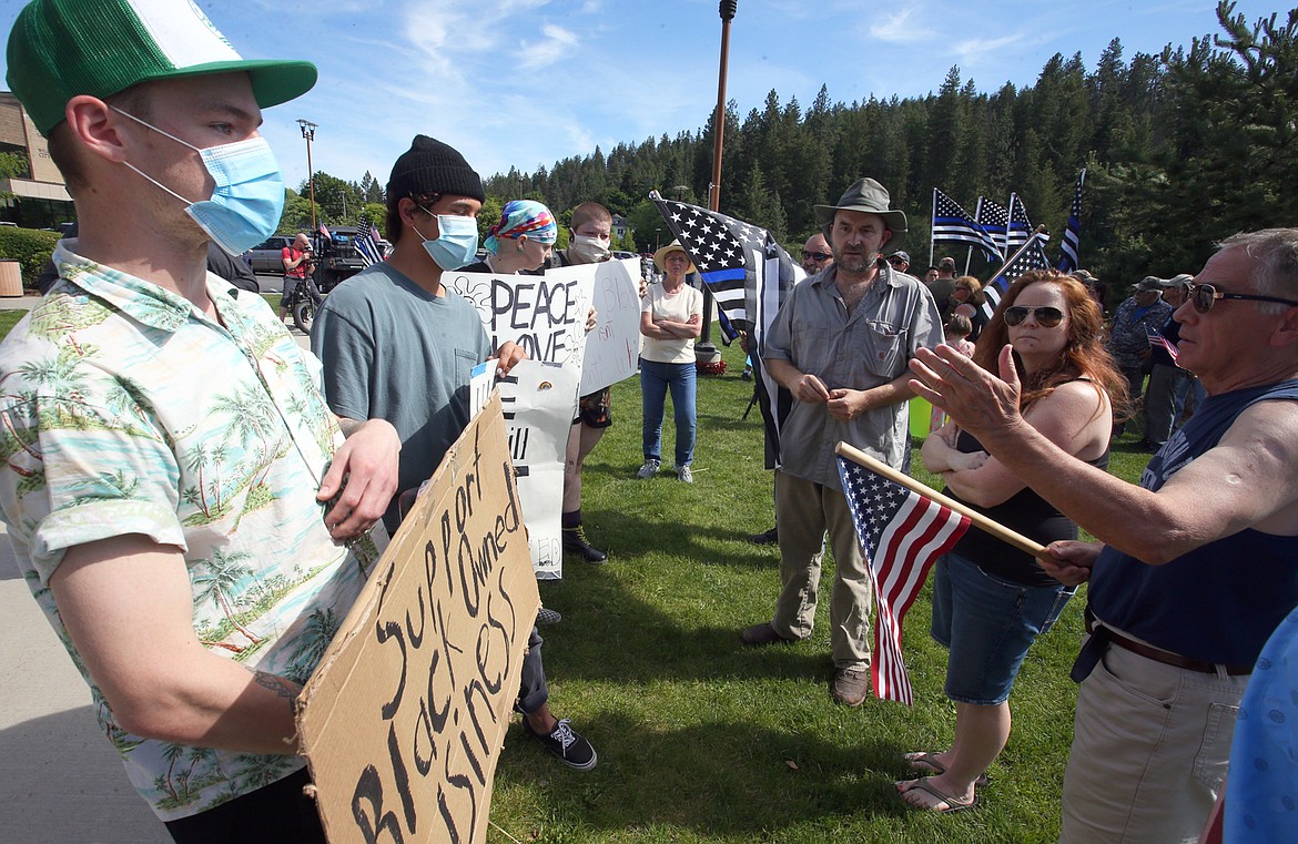 Protesters and counter-protesters exchange different viewpoints during a Black Lives Matter protest and counter-rally at McEuen Park on Tuesday.