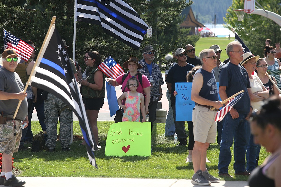 BILL BULEY/Press 
 Amanda Longpre stands with her daughter Emma, who holds a sign during a rally at McEuen Park on Tuesday.