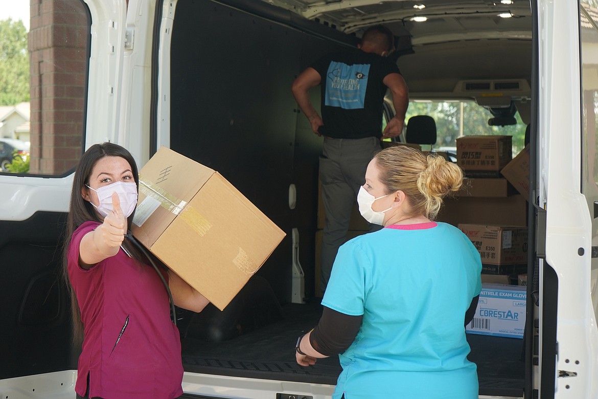 Heritage Health’s Stephanie Cellis gives the thumb’s up to personal medical equipment being delivered to the Coeur d’Alene Clinic.