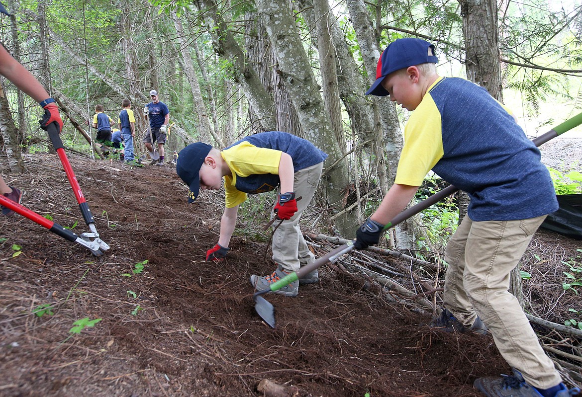 BILL BULEY/Press 
 Andy Nicholson, right, and brother Ate Nicholson work on a trail Saturday on Rathdrum Mountain.