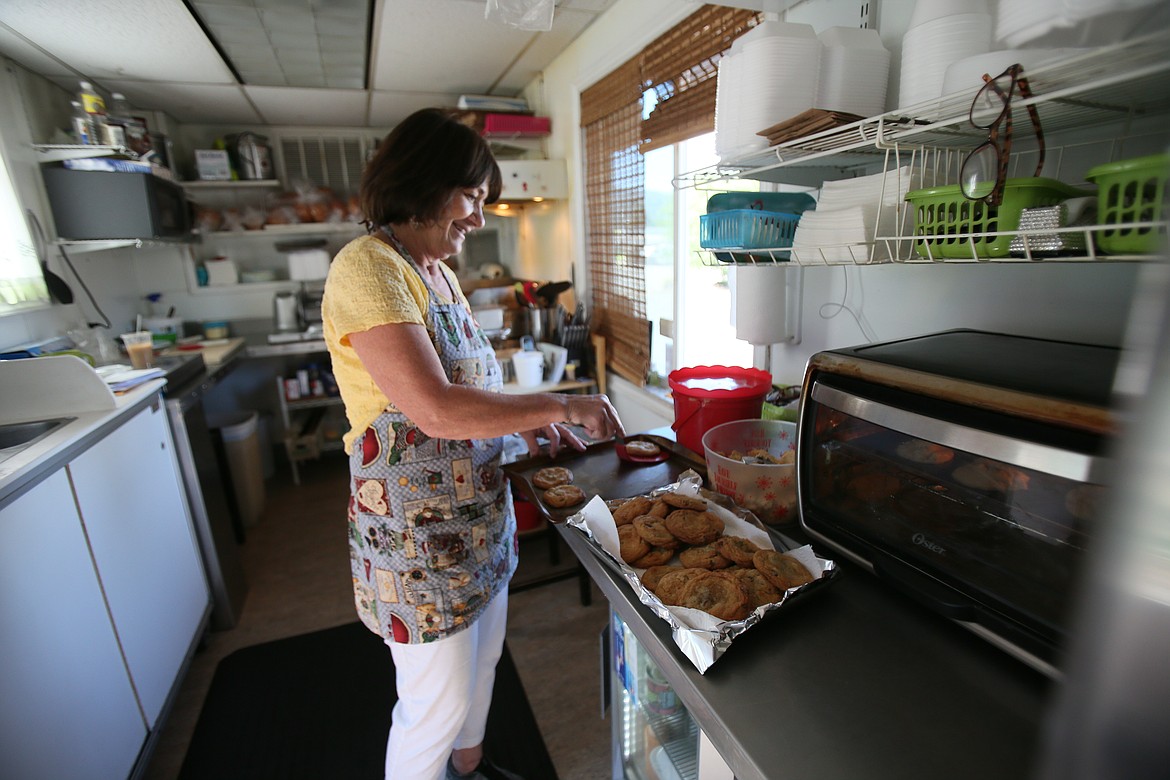 Mikele Williams, owner of Midtown Drive Up Deli in Post Falls, preps scratch-made cookies before opening. Williams bakes her unique homemade desserts in a toaster oven every morning.