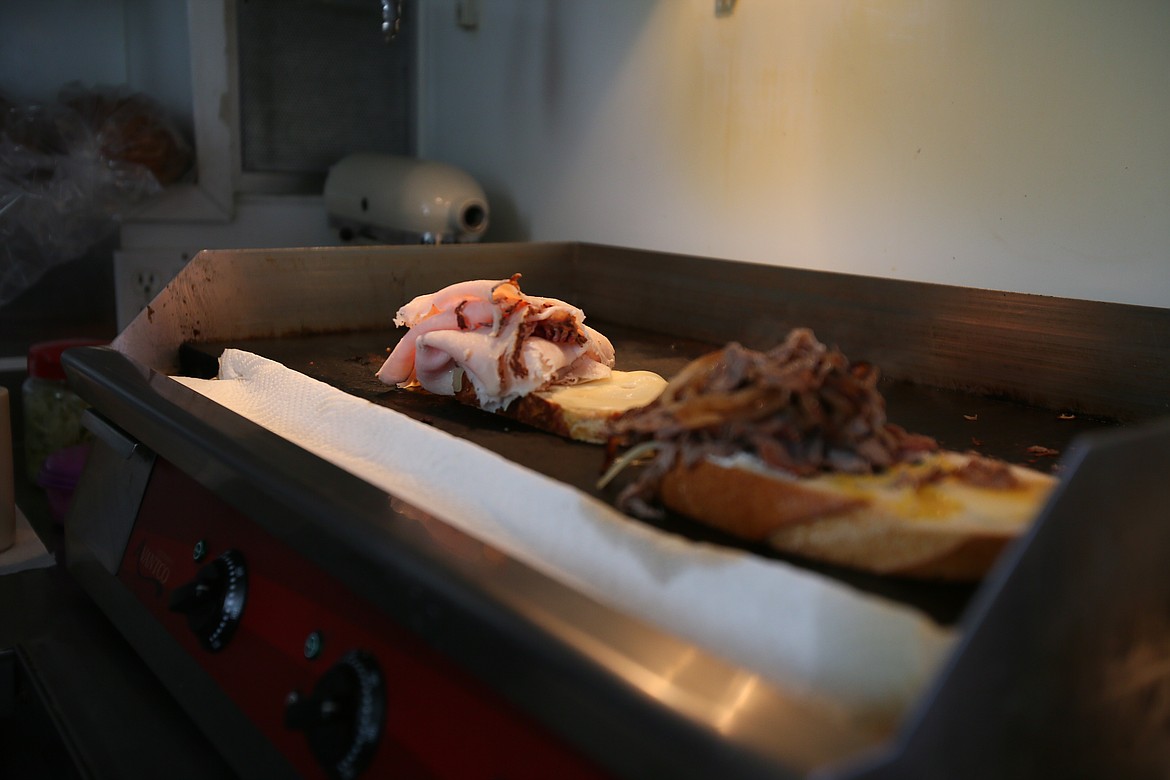 Half turkey and roast beef sandwiches are grilled in garlic butter before Midtown Drive Up Deli’s friendly workers send them off with hungry customers.