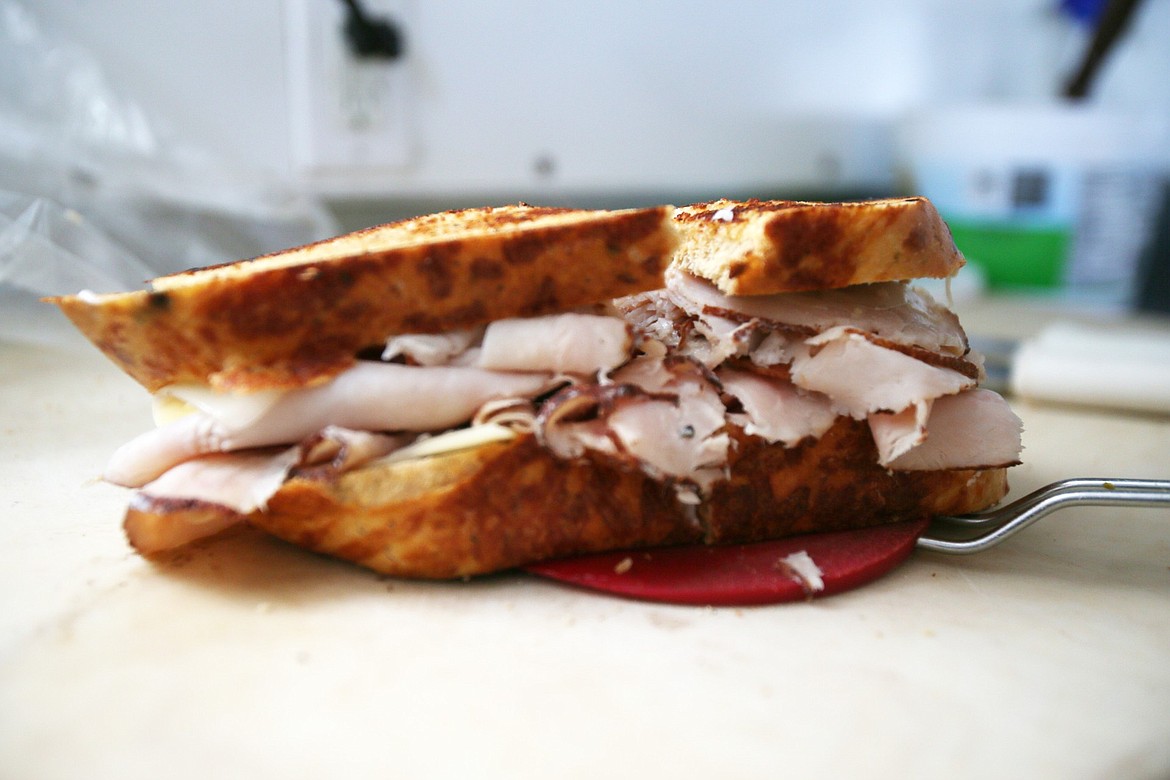 A turkey, bacon and Swiss cheese sandwich on tomato bread is hot off the grill at Midtown Drive Up Deli. This is one of several massive, mouth-watering sandwiches customers can build from the menu.