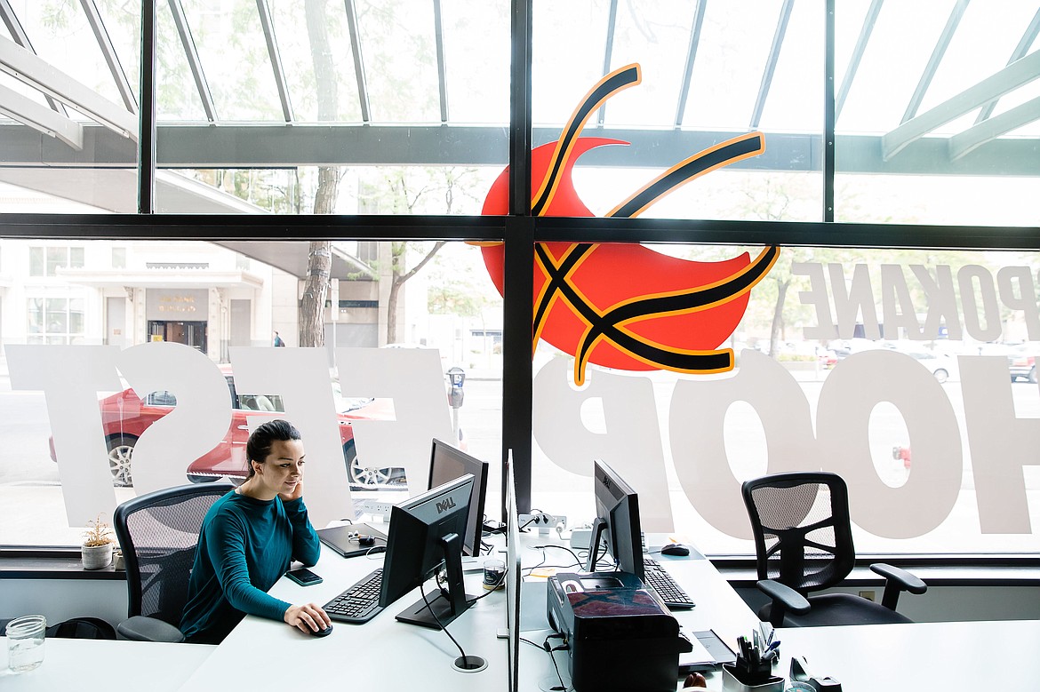 Kristi Atkinson, a marketing representative for HoopFest, works at her desk in the HoopFest office located on the first floor of the Paulsen Center.