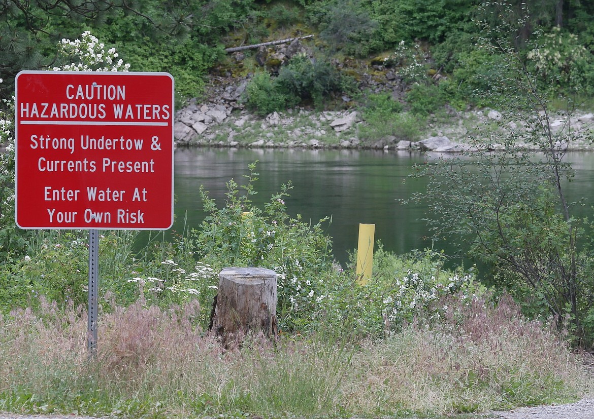 Signs like this one are posted around the Spokane River at Corbin Park, where rapids, eddies and a 30-foot underwater drop-off pose threats to summer recreators. Extreme caution and life jackets should be used in this stretch of the river.