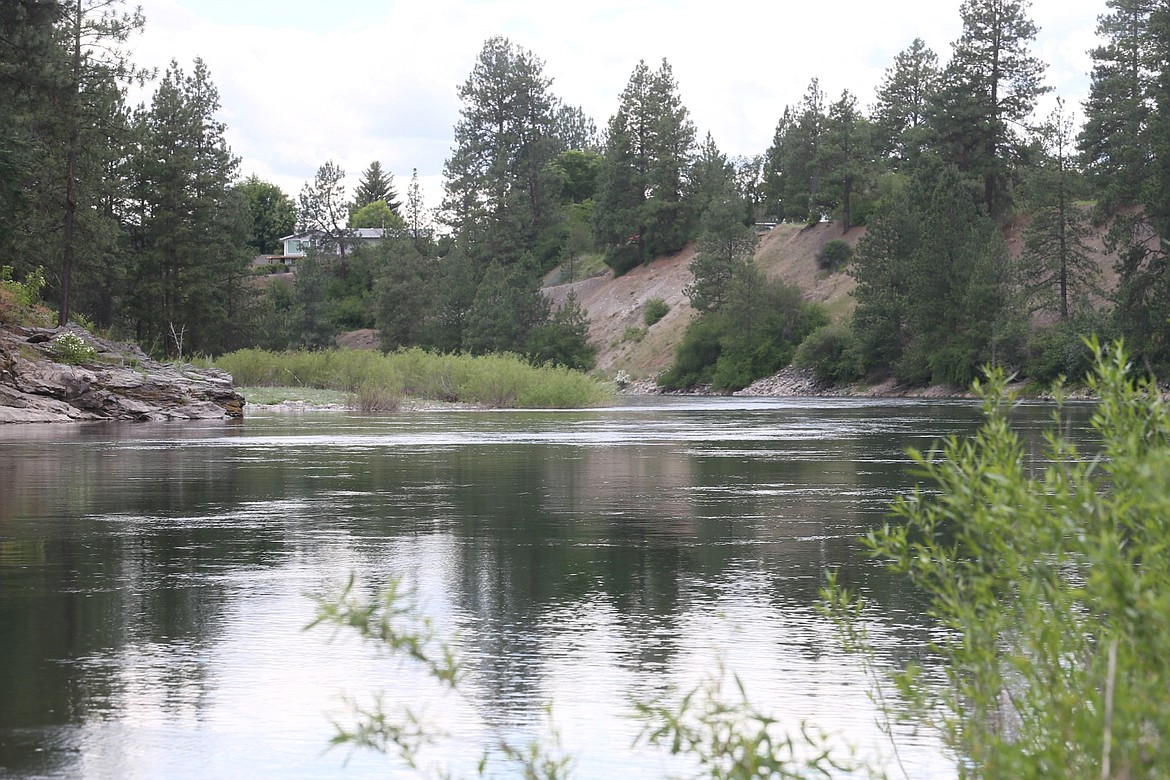 Swirling eddies and undertows make the Spokane River a dangerous place to recreate when the Post Falls Dam is still pushing out large volume of water. The river is seen here rushing westward on Monday.