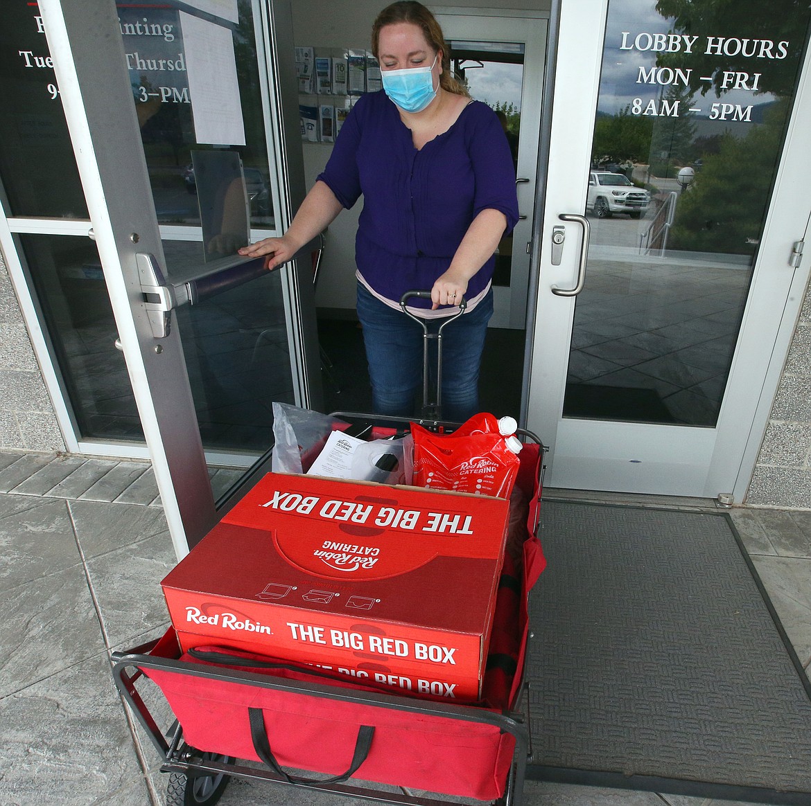 BILL BULEY/Press 
 Kayla Lundgren with Red Robin delivers a donation of about 25 lunches to the Coeur d'Alene Police Department on Monday.