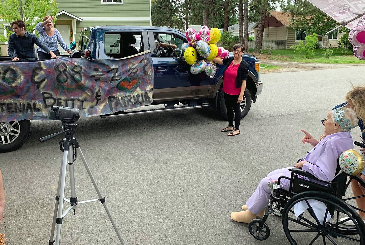 Passersby wish Betty Lundy Evans a happy 100th birthday on Saturday.